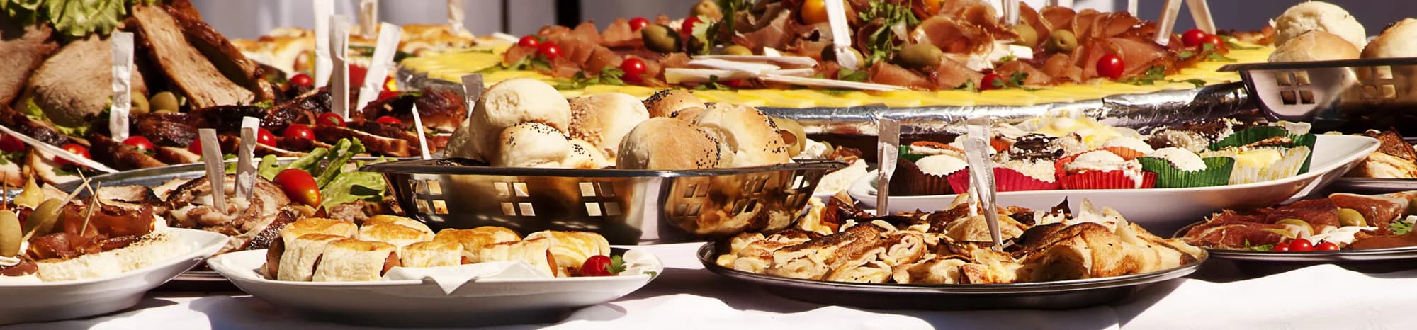 An abundant Sherm's Catering buffet spread of meats, breads and appetizers for a private event