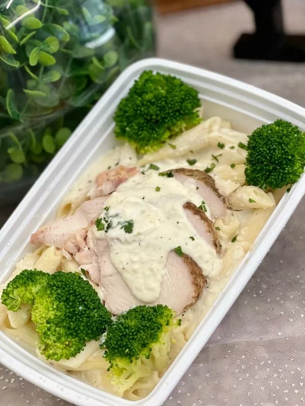 Sherm's Heat & Eat individual chicken alfredo penne meal with broccoli, ready to reheat for an office lunch